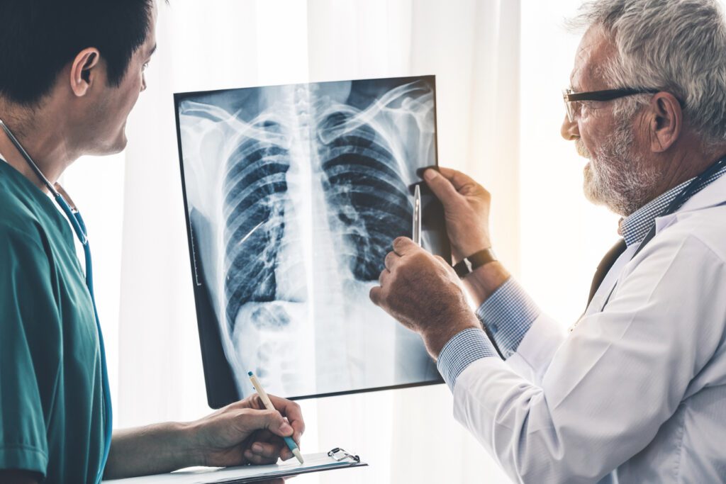 Medical doctor and radiologist examine chest x-ray