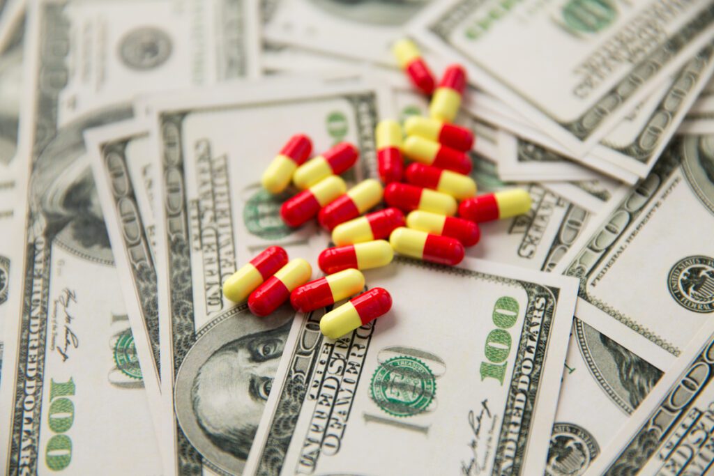 Pile of pills on U.S. $100 Dollar bills