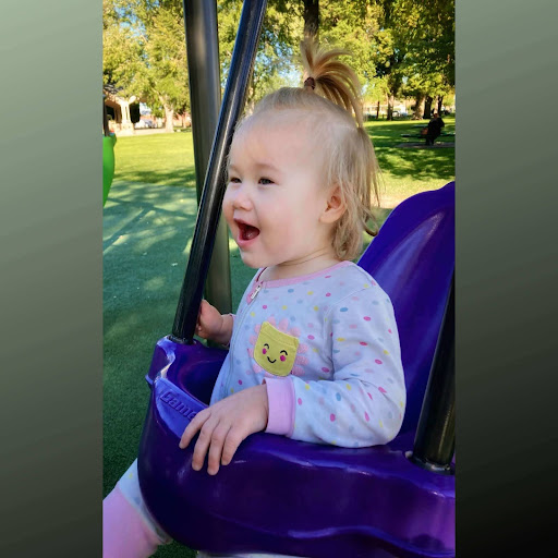 White baby girl in swing