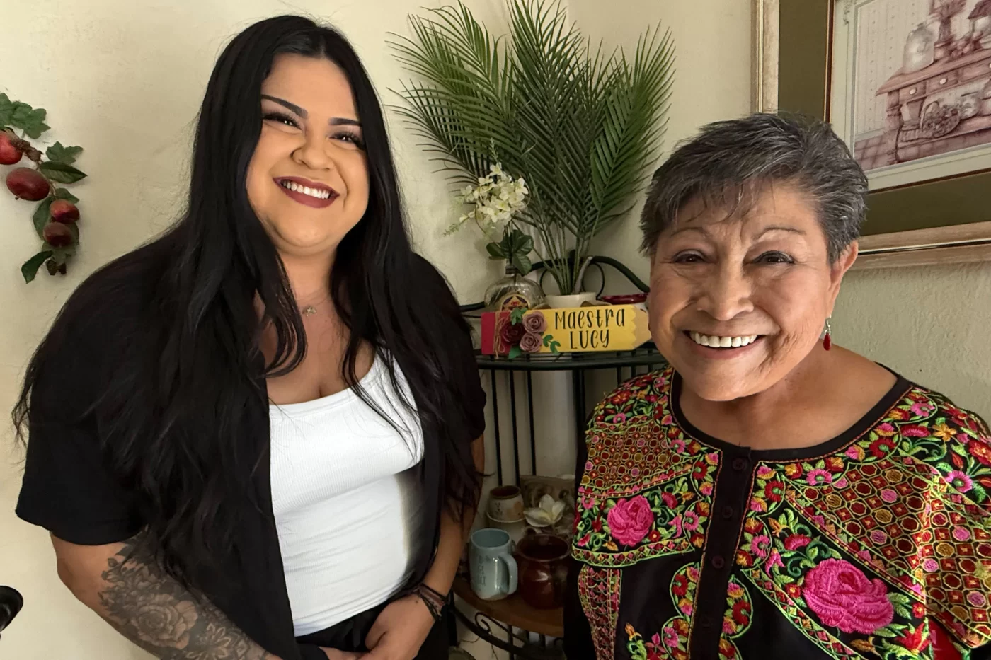 Josefina Linares (left), a care manager with the social services provider Titanium Healthcare, helps Medicaid patient Lucy Rodriguez manage her medical appointments and chronic diseases, and even helps pick up boxes of fresh fruits and vegetables for her.